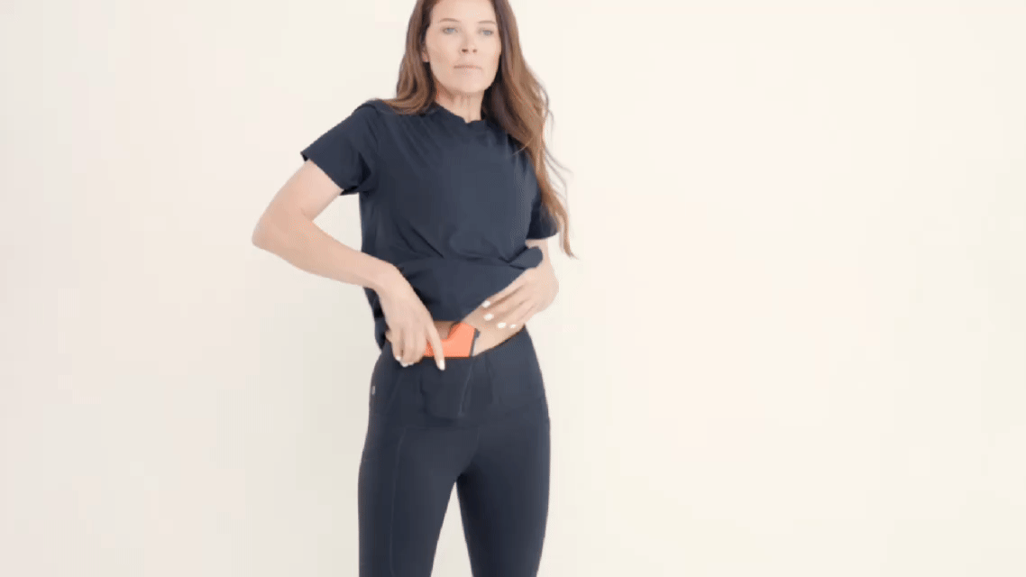 Byrna Alexo Athletica Matte 7/8 Carry  Black Legging - Zoomed front profile of model pulling out Byrna Gif